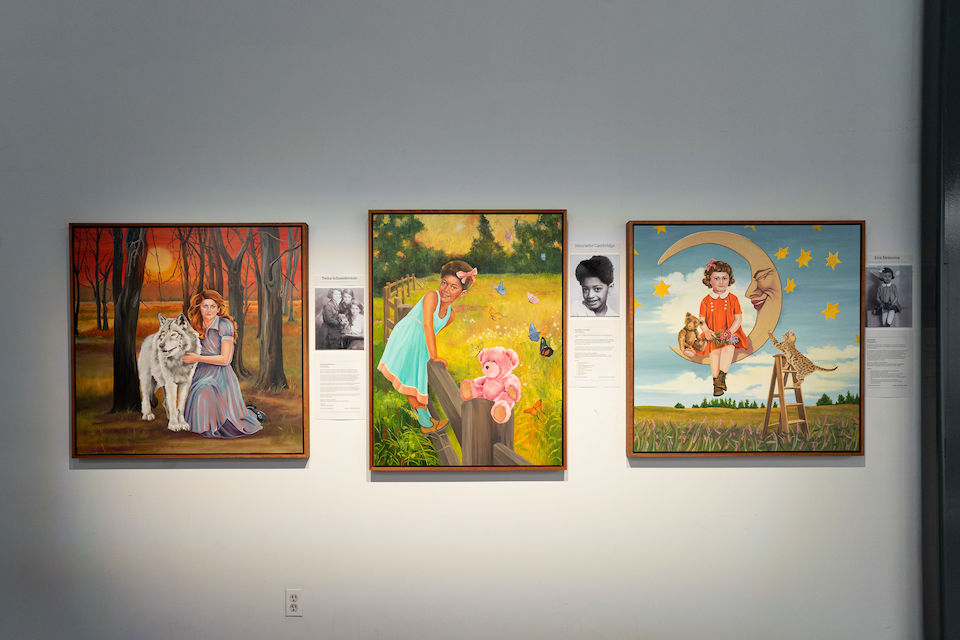 Paintings of young girls mounted on wall